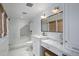 Clean bathroom design featuring white tiles, glass shower, and marble vanity at 19296 N 98Th Pl, Scottsdale, AZ 85255