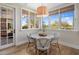 Sunlit breakfast nook with views of the yard with a charming round table and four chairs at 19296 N 98Th Pl, Scottsdale, AZ 85255