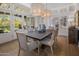 Elegant dining room with stylish light fixtures, seating for six, and sophisticated decor at 19296 N 98Th Pl, Scottsdale, AZ 85255
