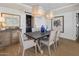 Elegant dining room with stylish light fixtures, seating for six, and sophisticated decor at 19296 N 98Th Pl, Scottsdale, AZ 85255