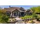 Stunning home showcasing lush landscaping, a stone facade, and charming architectural details at 19296 N 98Th Pl, Scottsdale, AZ 85255
