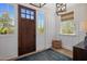 Bright foyer with wood floors, shiplap walls, and a stylish light fixture offering a warm entrance at 19296 N 98Th Pl, Scottsdale, AZ 85255