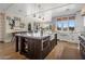 Spacious kitchen with a large island, farmhouse sink, modern appliances, and ample natural light at 19296 N 98Th Pl, Scottsdale, AZ 85255