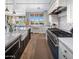Bright kitchen featuring farmhouse sink, white cabinetry, marble countertops, and stainless steel appliances at 19296 N 98Th Pl, Scottsdale, AZ 85255