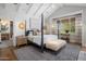 Tranquil main bedroom with a four-poster bed, vaulted ceilings, a seating area, and serene decor at 19296 N 98Th Pl, Scottsdale, AZ 85255