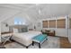 Bright bedroom with vaulted ceilings, white shiplap and a cozy seating area at 19296 N 98Th Pl, Scottsdale, AZ 85255
