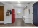 Well-organized mudroom with built-in storage, seating, and a vibrant red refrigerator at 19296 N 98Th Pl, Scottsdale, AZ 85255