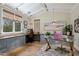 Bright home office with vaulted ceilings, custom cabinets, a glass desk, and large windows overlooking the lawn at 19296 N 98Th Pl, Scottsdale, AZ 85255