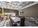 Outdoor dining area under a pergola with a built-in grill and stone accents at 19296 N 98Th Pl, Scottsdale, AZ 85255