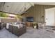 Covered outdoor patio area with a comfortable seating area and media center at 19296 N 98Th Pl, Scottsdale, AZ 85255