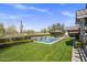 Inviting pool area with stone accents, lush landscaping, and desert views creates a private oasis at 19296 N 98Th Pl, Scottsdale, AZ 85255
