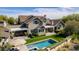 Beautiful home with a backyard oasis featuring a pool, lush greenery, and a pergola-covered dining area at 19296 N 98Th Pl, Scottsdale, AZ 85255