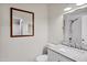 Bathroom featuring granite countertops, framed mirror and white cabinets at 195 N Cottonwood St # 26, Chandler, AZ 85225