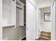 Walk-in closet with shelves and an open door to the hallway and bathroom at 195 N Cottonwood St # 26, Chandler, AZ 85225
