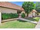 Charming single-story home features a well-maintained lawn, desert landscaping, and a vibrant, tiled roof at 195 N Cottonwood St # 26, Chandler, AZ 85225