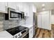 Bright kitchen showcasing stainless steel appliances, white cabinets, and modern countertops at 195 N Cottonwood St # 26, Chandler, AZ 85225