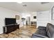 Open-concept living room with wood-look flooring and a view of the updated kitchen, perfect for entertaining at 195 N Cottonwood St # 26, Chandler, AZ 85225