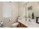 Half-bathroom featuring a sink, a toilet, and a framed mirror at 1955 E Grand Canyon Dr, Chandler, AZ 85249