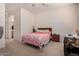 Bright bedroom with carpet, a ceiling fan, and a wooden headboard at 1955 E Grand Canyon Dr, Chandler, AZ 85249