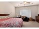 Cozy bedroom featuring carpet, a ceiling fan, and a large window at 1955 E Grand Canyon Dr, Chandler, AZ 85249