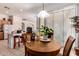 Bright dining area with wood table, tile floors, and natural light from the sliding glass door at 1955 E Grand Canyon Dr, Chandler, AZ 85249