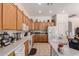 Well-lit kitchen featuring tile floors, light wood cabinets, and modern appliances at 1955 E Grand Canyon Dr, Chandler, AZ 85249