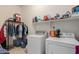 Efficient laundry room with modern appliances and shelving for storage at 1955 E Grand Canyon Dr, Chandler, AZ 85249