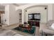 Open-concept living room featuring carpeted floors, arched doorways and a tv at 1955 E Grand Canyon Dr, Chandler, AZ 85249