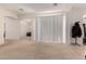 Bright and airy living room with carpeted floors, large blinds, and arched doorways at 1955 E Grand Canyon Dr, Chandler, AZ 85249