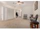 Inviting living room featuring plush carpeting, neutral walls, and a ceiling fan at 1955 E Grand Canyon Dr, Chandler, AZ 85249