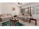 Comfortable living room featuring carpet, couches, a ceiling fan and natural light at 1955 E Grand Canyon Dr, Chandler, AZ 85249