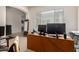 Office with multiple monitors, a large desk, and neutral carpeting at 1955 E Grand Canyon Dr, Chandler, AZ 85249