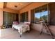 Covered patio offering an outdoor living space with a table and chairs at 1955 E Grand Canyon Dr, Chandler, AZ 85249