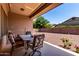Comfortable covered patio with outdoor seating, views of the backyard, and sunny skies at 1955 E Grand Canyon Dr, Chandler, AZ 85249