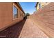 Side yard shows privacy wall with gravel ground cover and exterior window view at 1955 E Grand Canyon Dr, Chandler, AZ 85249