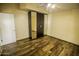 Bedroom features laminate floors, ceiling fan, and mirrored closet doors at 20221 N 31St St, Phoenix, AZ 85050