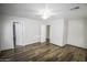 Bedroom featuring a ceiling fan, wood floors, and two doors at 20221 N 31St St, Phoenix, AZ 85050