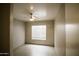 Bedroom features a ceiling fan and a window at 20221 N 31St St, Phoenix, AZ 85050