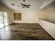 Spacious living area featuring hardwood floors, ceiling fan, and sliding glass doors to a balcony at 20221 N 31St St, Phoenix, AZ 85050