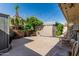 Backyard patio surrounded by greenery, palm trees, and outdoor seating under string lights at 2041 W Pierson St, Phoenix, AZ 85015