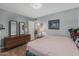 Bedroom featuring a dresser, nightstand, and decoratively framed paintings at 2041 W Pierson St, Phoenix, AZ 85015