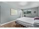 Serene bedroom with neutral walls, tile floors, and ample natural light at 2041 W Pierson St, Phoenix, AZ 85015
