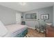 Bedroom with light blue walls, a window, and minimal decor including an exercise bike at 2041 W Pierson St, Phoenix, AZ 85015
