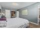 Comfortable bedroom featuring tile floors, a large window, and a view of the en suite at 2041 W Pierson St, Phoenix, AZ 85015