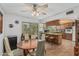 Cozy kitchen and dining area featuring tile floors, wooden cabinets, and stainless steel ceiling fan at 2041 W Pierson St, Phoenix, AZ 85015