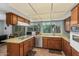 Well-lit kitchen featuring stainless steel appliances, wood cabinets, and large windows at 2041 W Pierson St, Phoenix, AZ 85015