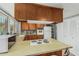 Bright kitchen featuring wood cabinets, matching appliances, and lots of pantry space at 2041 W Pierson St, Phoenix, AZ 85015