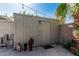 Exterior shot of a backyard shed with desert themed decor and string lights overhead at 2041 W Pierson St, Phoenix, AZ 85015