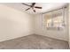 A bright bedroom with a ceiling fan and a large window overlooking the exterior at 2134 E Broadway Rd # 1062, Tempe, AZ 85282