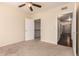 Carpeted bedroom with a ceiling fan and doors to closet and hallway at 2134 E Broadway Rd # 1062, Tempe, AZ 85282